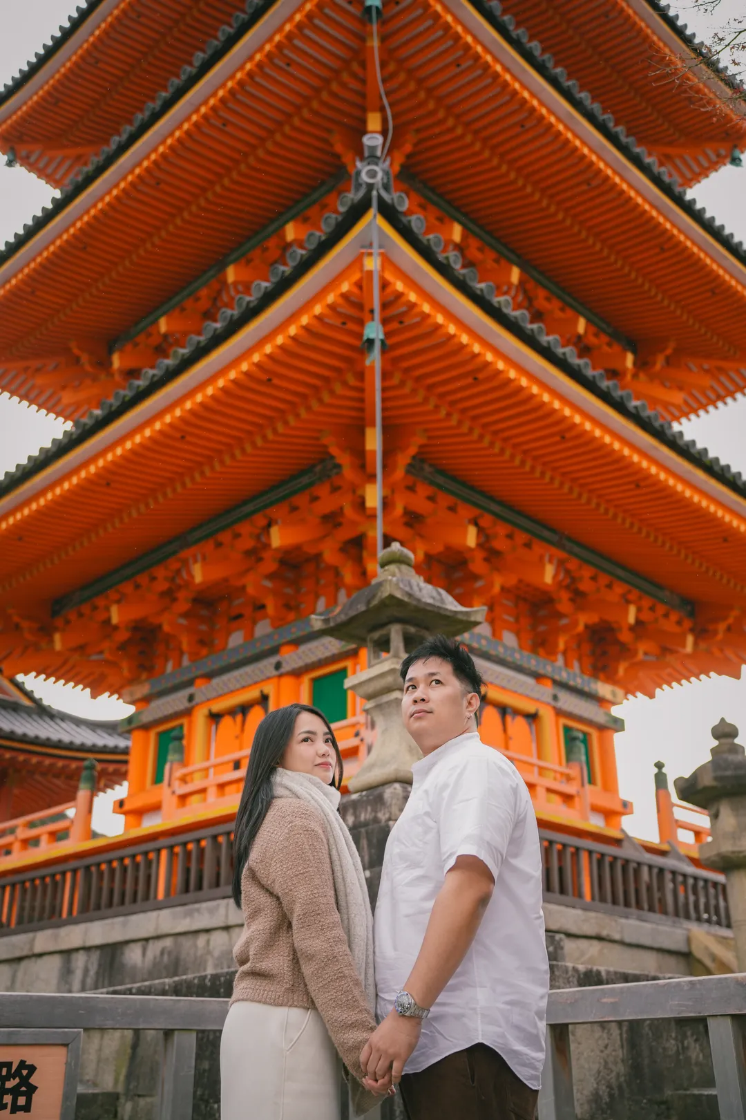 Hand in hand beneath the vermillion pagoda