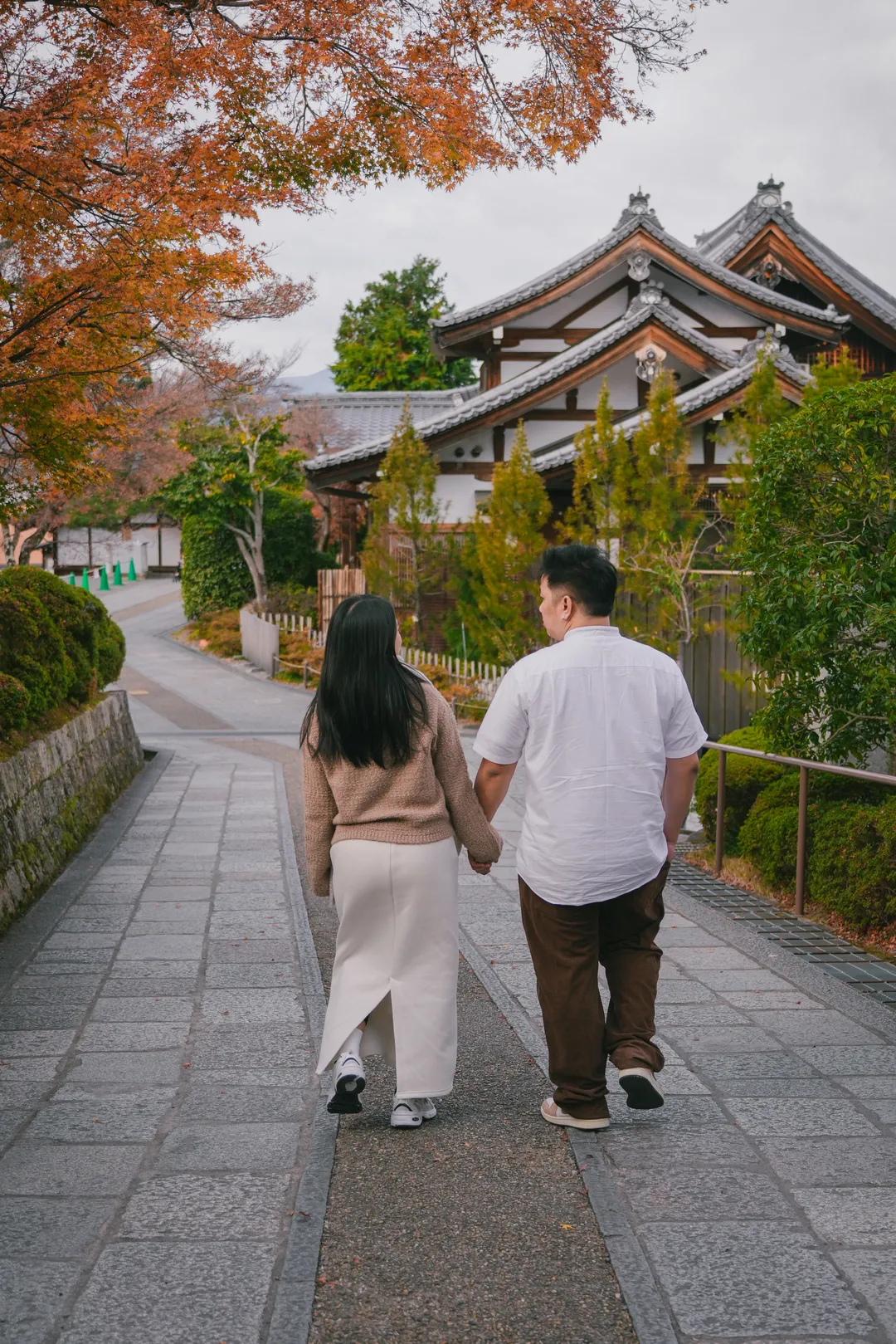 Walking away hand in hand down the temple path